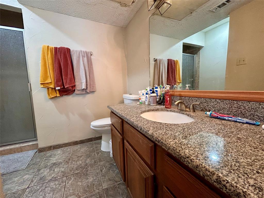 806 West 24th Street, Unit 233 Austin, TX 78705 - Photo 5 of 5 a bathroom with a granite countertop sink and a mirror