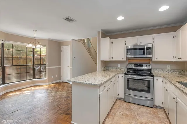 a kitchen with granite countertop a stove and a sink