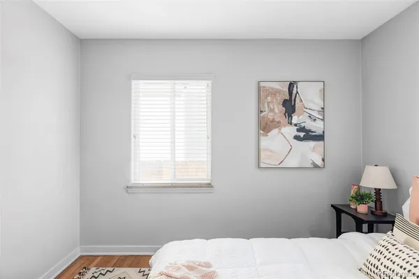 a bedroom with a bed and window