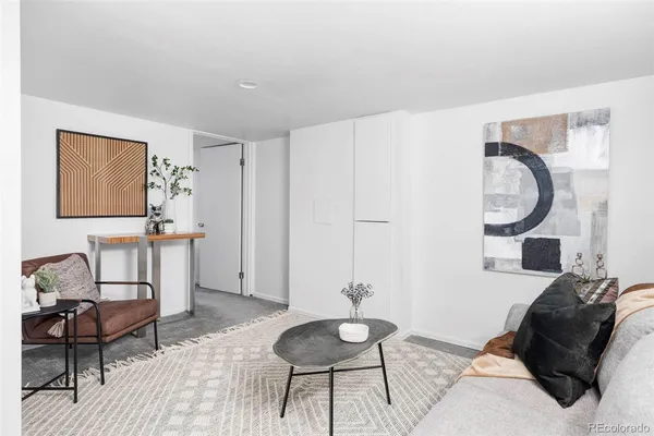 a living room with furniture and a mirror