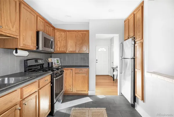 a kitchen with stainless steel appliances granite countertop a refrigerator stove and sink