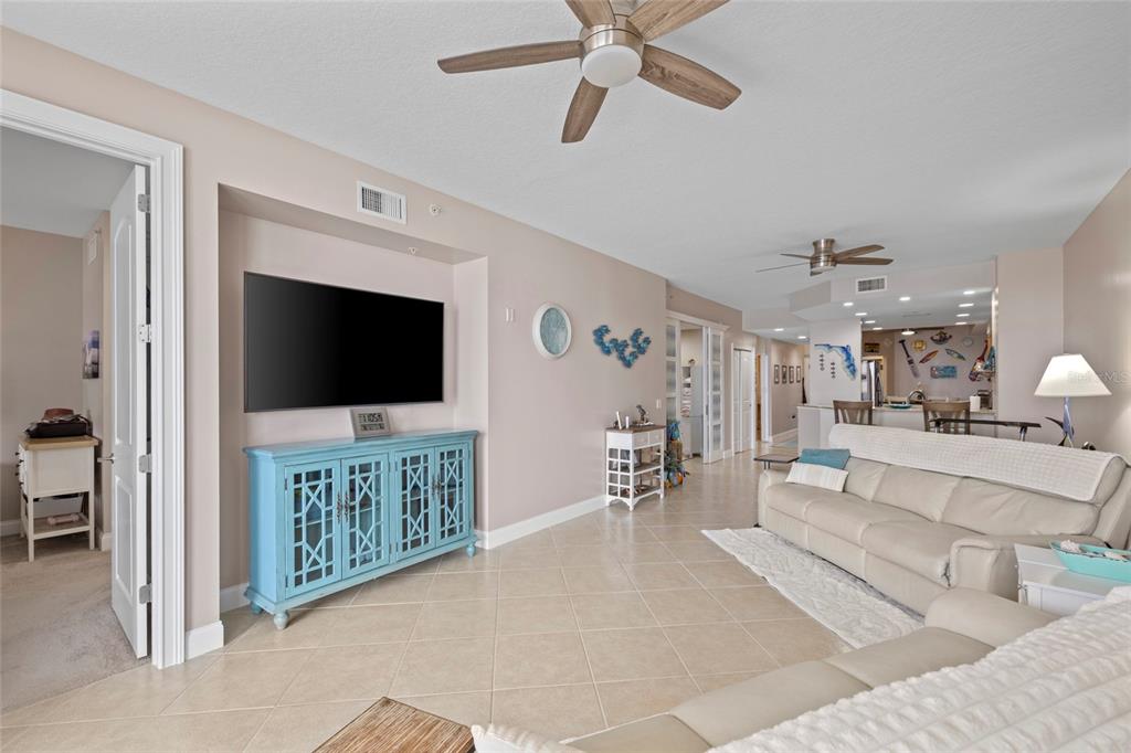 615 Riviera Dunes Way, Unit 204 Palmetto, FL 34221 - Photo 15 of 43 a living room with furniture and a flat screen tv
