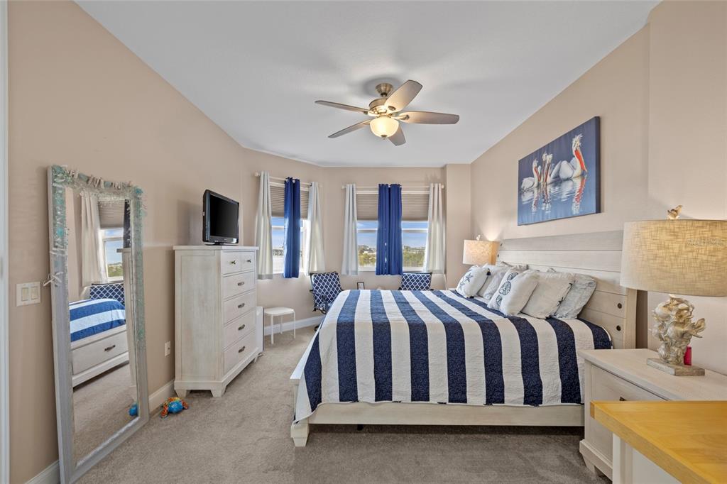 615 Riviera Dunes Way, Unit 204 Palmetto, FL 34221 - Photo 17 of 43 a bedroom with a bed and a chandelier