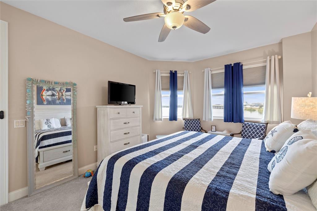 615 Riviera Dunes Way, Unit 204 Palmetto, FL 34221 - Photo 18 of 43 a bedroom with a bed and a flat screen tv
