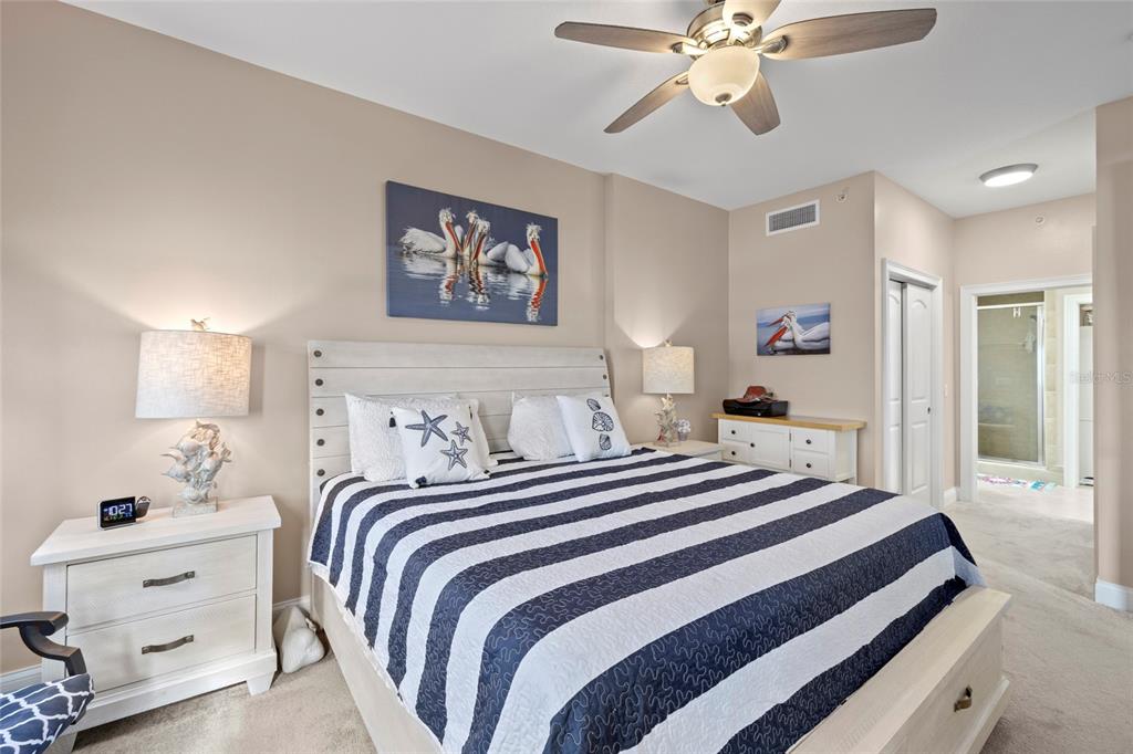 615 Riviera Dunes Way, Unit 204 Palmetto, FL 34221 - Photo 19 of 43 a bedroom with a bed and a chandelier