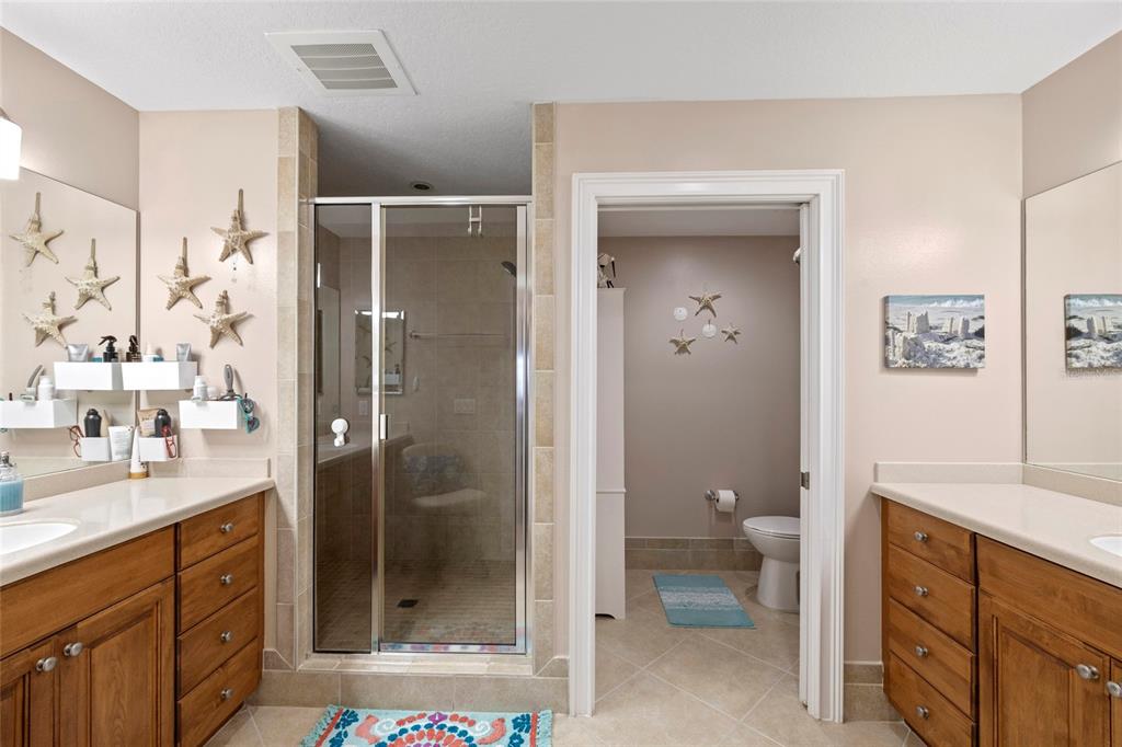 615 Riviera Dunes Way, Unit 204 Palmetto, FL 34221 - Photo 21 of 43 a bathroom with a sink a toilet and shower