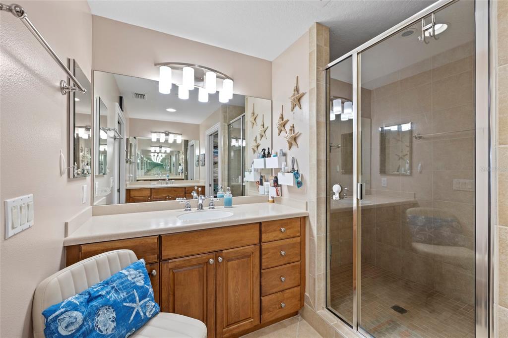 615 Riviera Dunes Way, Unit 204 Palmetto, FL 34221 - Photo 23 of 43 a bathroom with a sink mirror and a bathtub