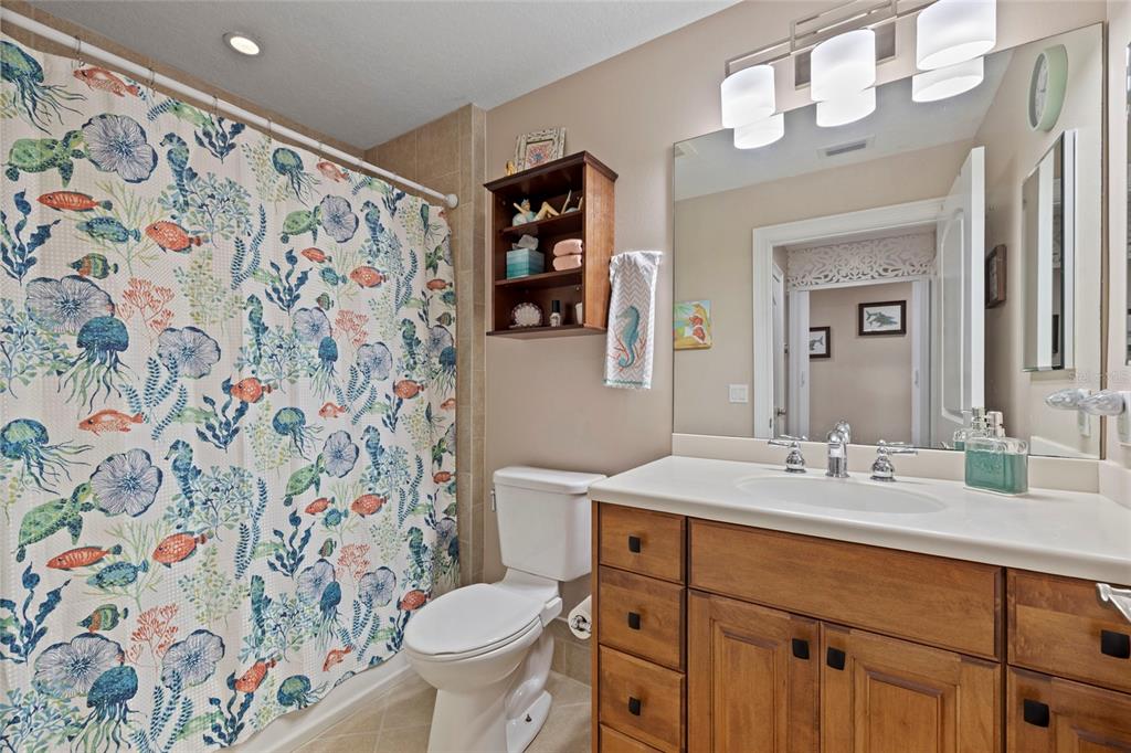 615 Riviera Dunes Way, Unit 204 Palmetto, FL 34221 - Photo 27 of 43 a bathroom with a sink and a mirror