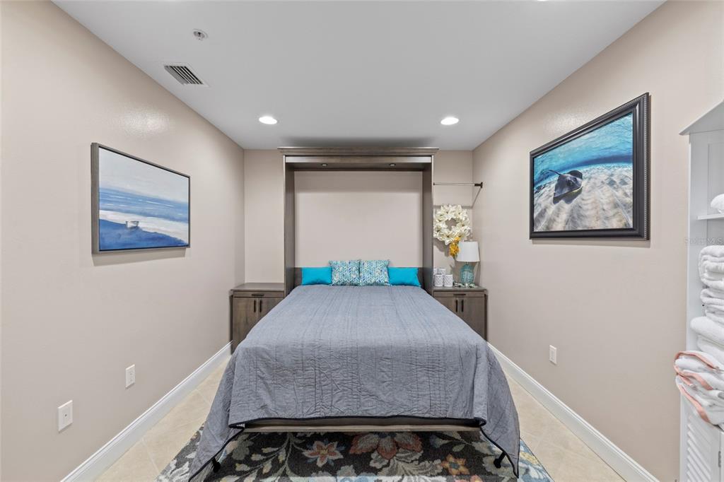 615 Riviera Dunes Way, Unit 204 Palmetto, FL 34221 - Photo 28 of 43 a hallway with a large bed and a potted plant