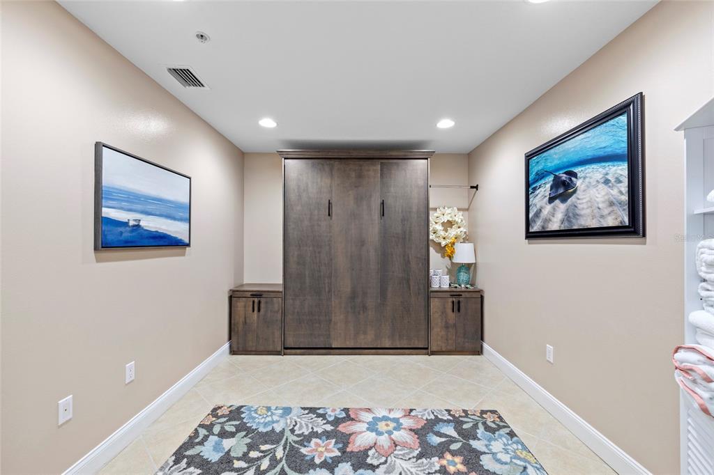 615 Riviera Dunes Way, Unit 204 Palmetto, FL 34221 - Photo 29 of 43 a view of a hallway with wooden floor and cabinet