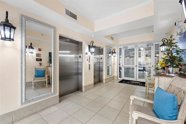 a view of a hallway with paintings on the wall and a window