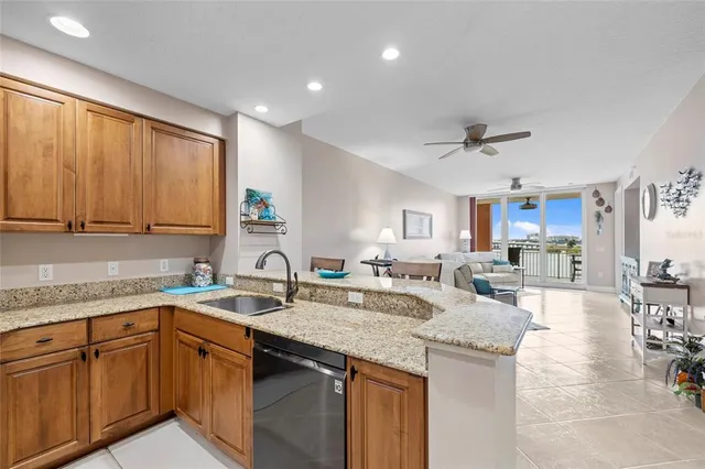 a kitchen with a sink dishwasher a stove and cabinets with wooden floor
