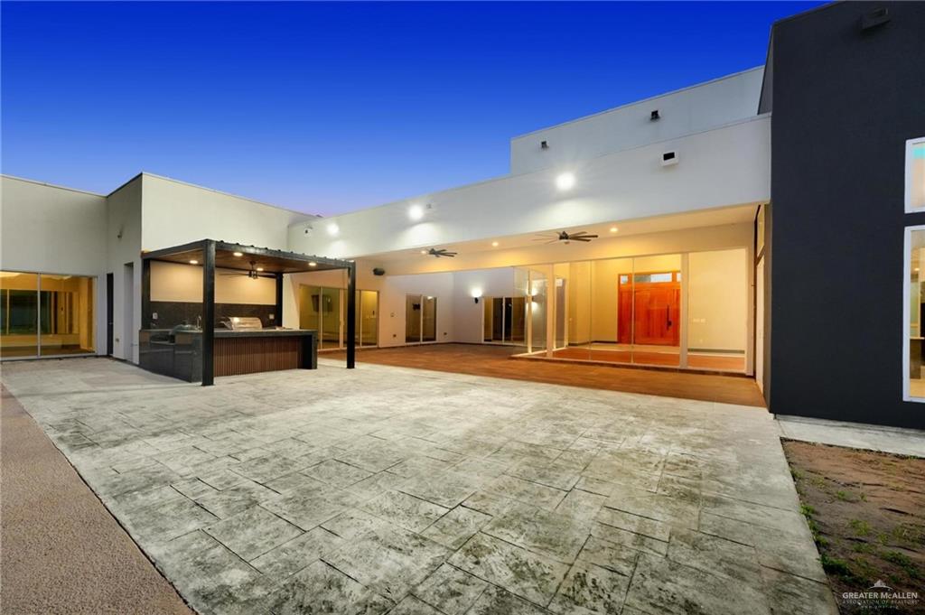 2321 Martha's Lane Mission, TX 78573 - Photo 34 of 36 Back house at dusk featuring area for grilling, ceiling fan, and a patio area