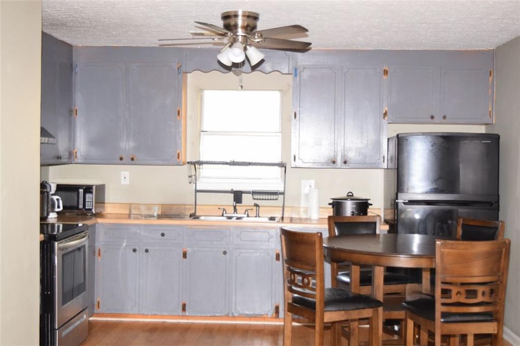 705 Triune Mill Road Thomaston, GA 30286 - Photo 20 of 39 a kitchen with stainless steel appliances a sink a stove a refrigerator cabinets and a window