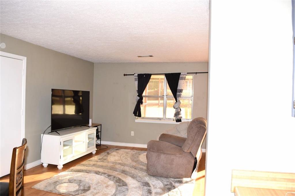 705 Triune Mill Road Thomaston, GA 30286 - Photo 21 of 39 a living room with furniture and a flat screen tv