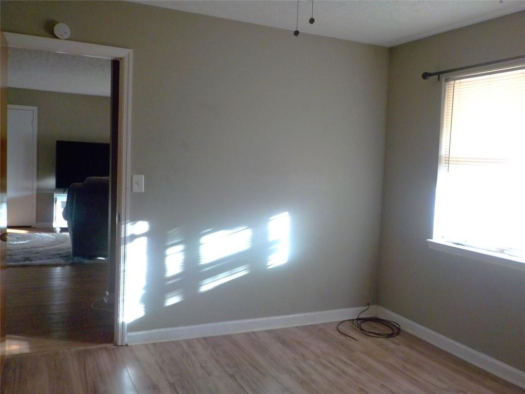 705 Triune Mill Road Thomaston, GA 30286 - Photo 28 of 39 a view of empty room with wooden floor and fan