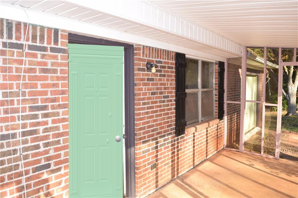 705 Triune Mill Road Thomaston, GA 30286 - Photo 3 of 39 a view of a brick house with a large window