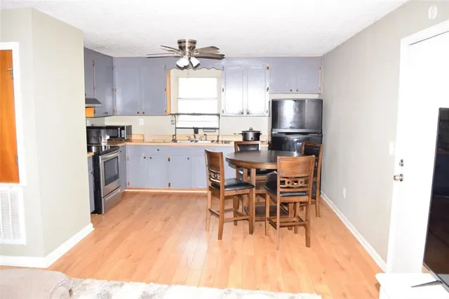 a kitchen with a sink a window and stainless steel appliances