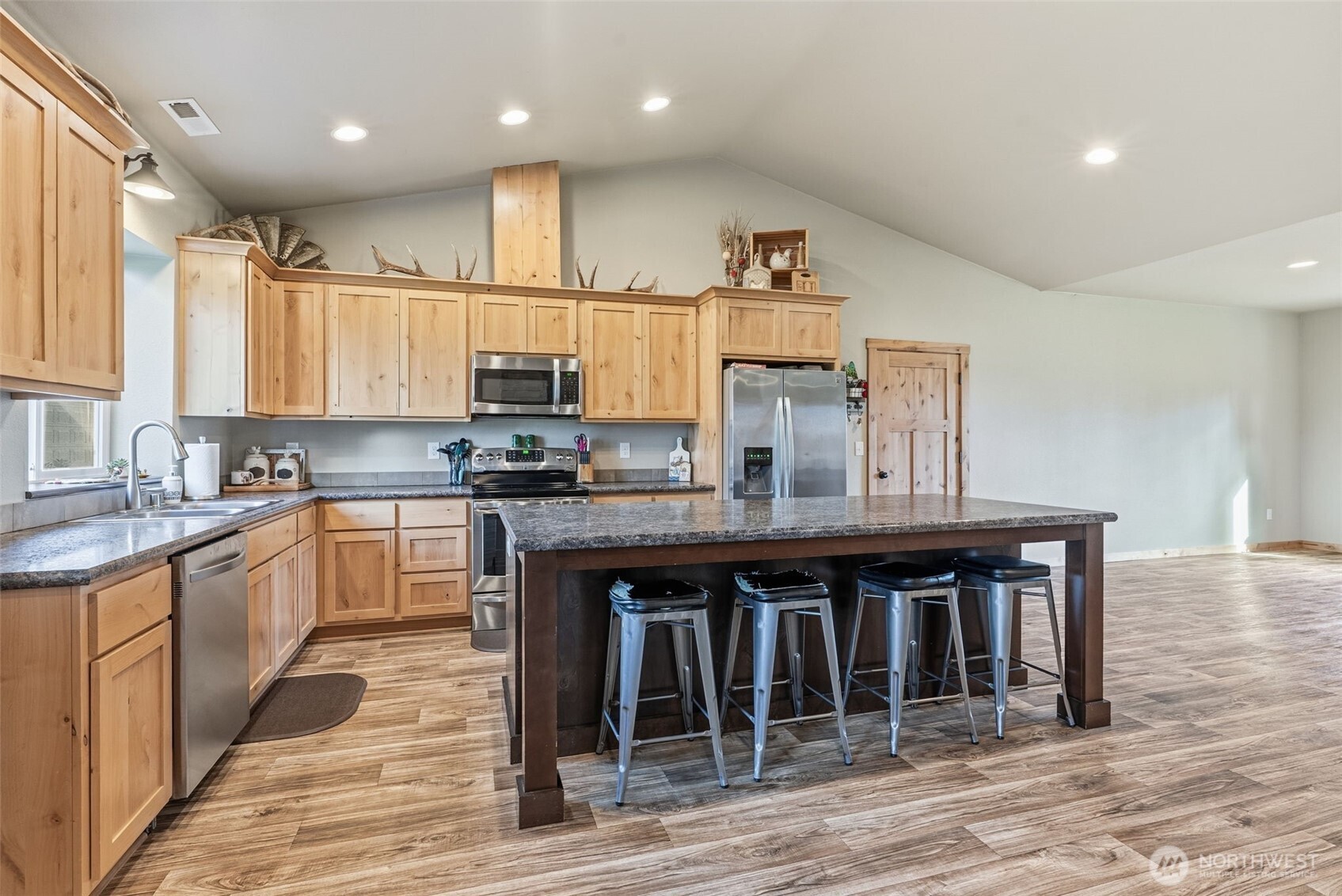 371 Toledo-Vader Road Toledo, WA 98591 - Photo 18 of 40 a kitchen with stainless steel appliances granite countertop a stove a sink dishwasher and a refrigerator with wooden floor