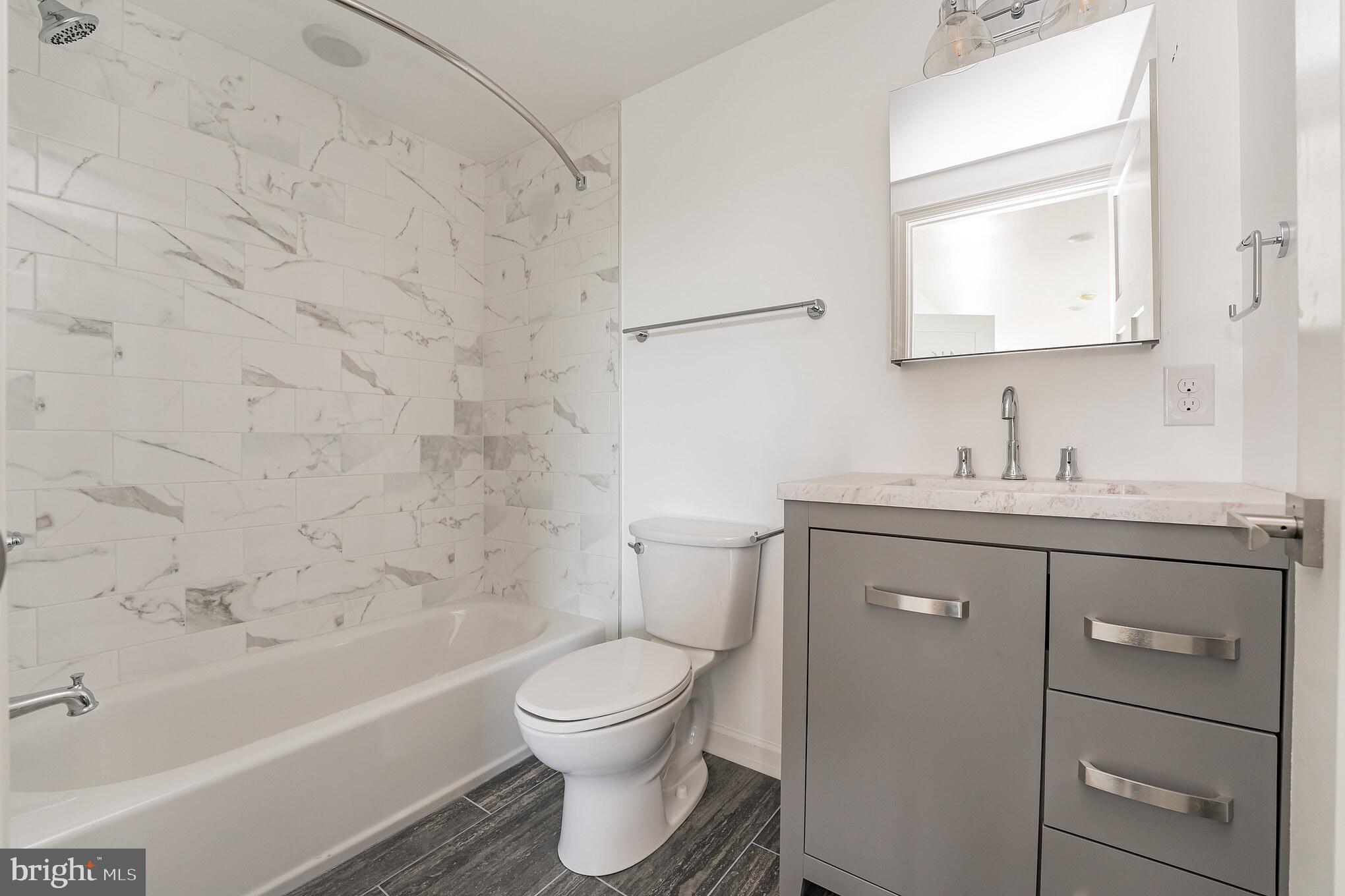 6649 Ridge Avenue, Unit B302 Philadelphia, PA 19128 - Photo 6 of 9 a bathroom with a sink toilet and shower