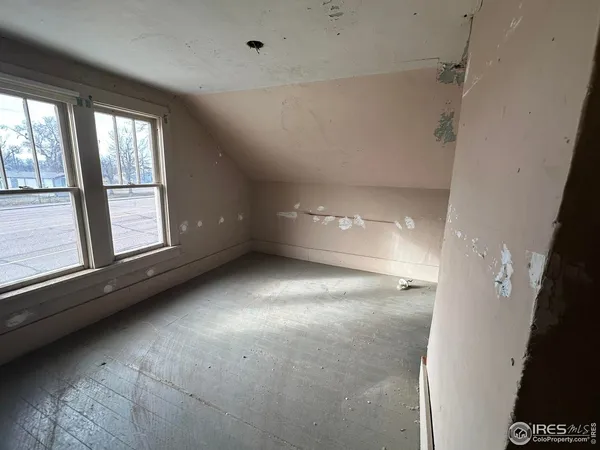 a view of entryway with wooden floor and windows
