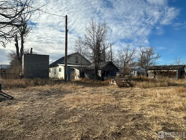 a front view of a house with cars parked