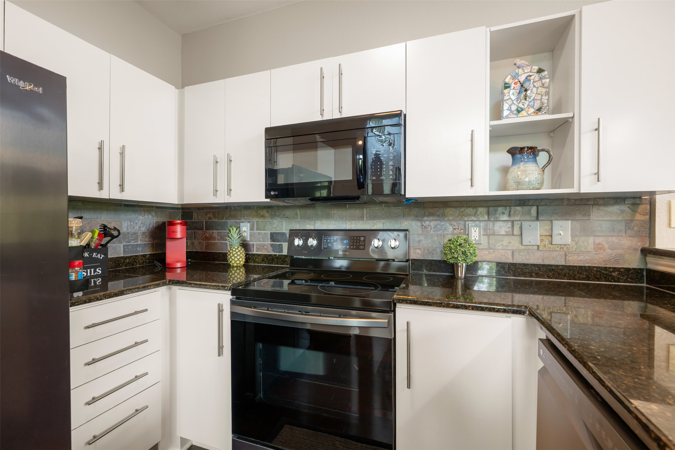 11203 Ranch Road 2222, Unit 1407 Austin, TX 78732 - Photo 25 of 40 The kitchen boasts stainless appliances including an electric range, microwave, dishwasher, and French door refrigerator - all included!