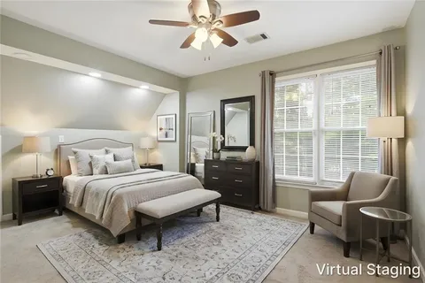 a bedroom with a bed couch and a window