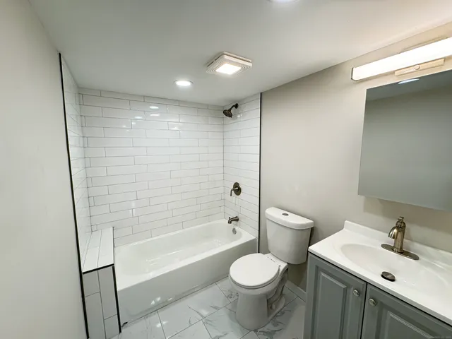 a bathroom with a toilet a sink and bathtub