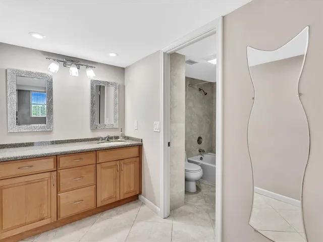 a bathroom with a double vanity sink and a mirror