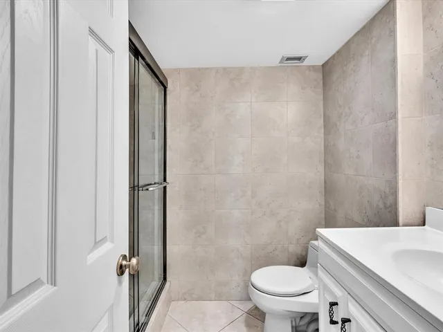 a bathroom with a sink a toilet and mirror