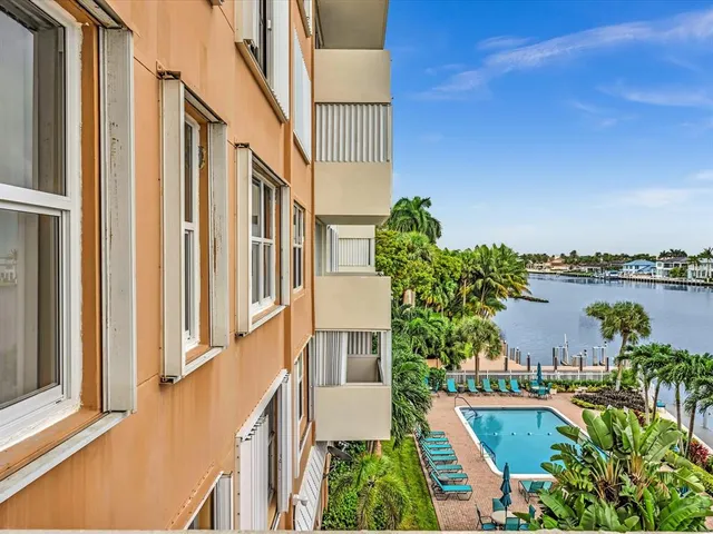 a view of a swimming pool and outdoor seating