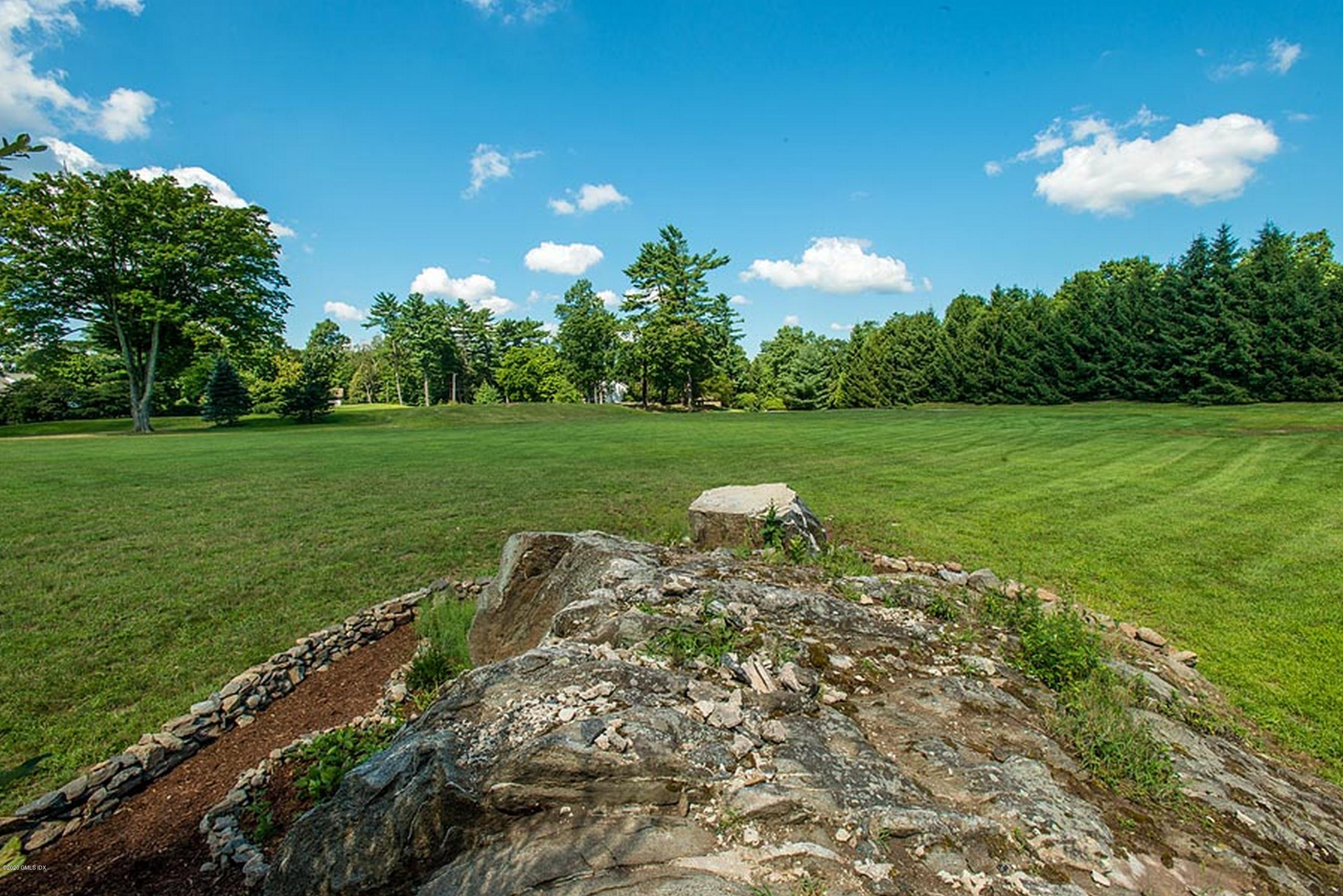 137 Doubling Road Greenwich, CT 06830 - Photo 9 of 12 a view of a golf course with a table and a fire pit