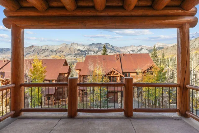 a bedroom with a bed and a large window with outer view