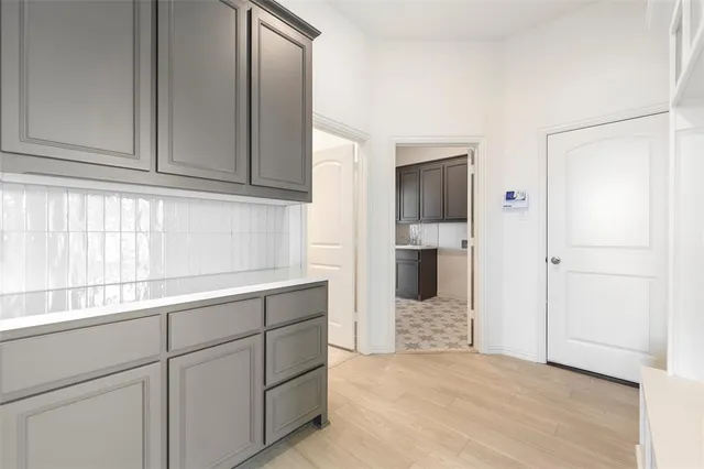 a view of a kitchen with wooden cabinet and staircase
