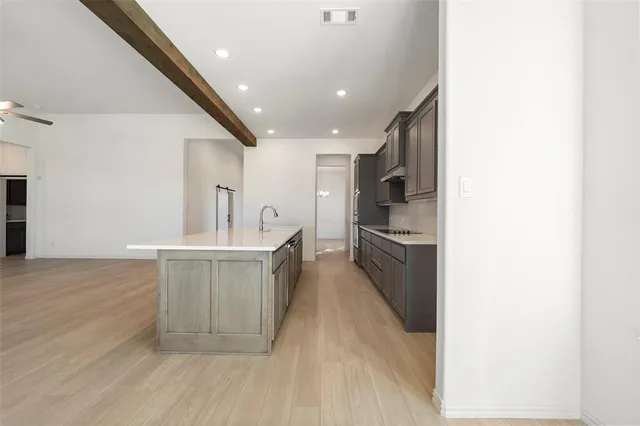 a kitchen with a sink stainless steel appliances and cabinets