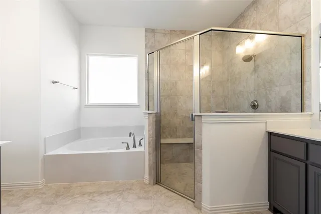a bathroom with a bathtub and a shower