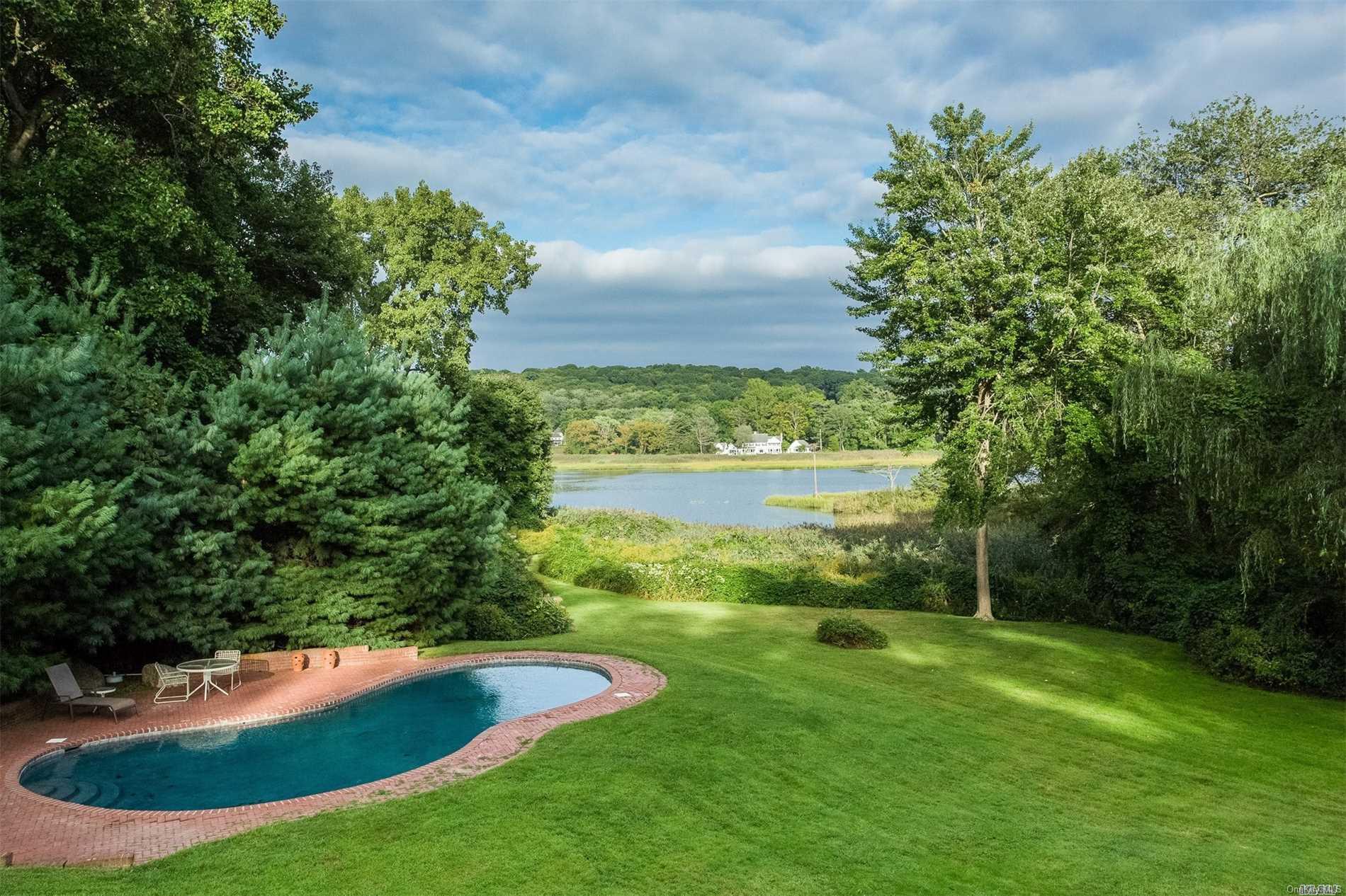 163 Factory Pond Road Mill Neck, NY 11560 - Photo 1 of 1 In ground Pool with lawn leading to dock