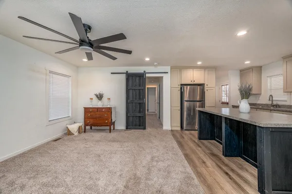 a view of kitchen with stainless steel appliances kitchen island sink stove and refrigerator