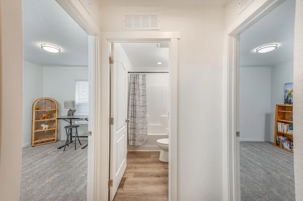 a view of hallway with livingroom and furniture