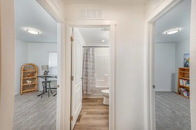 a view of hallway with livingroom and furniture