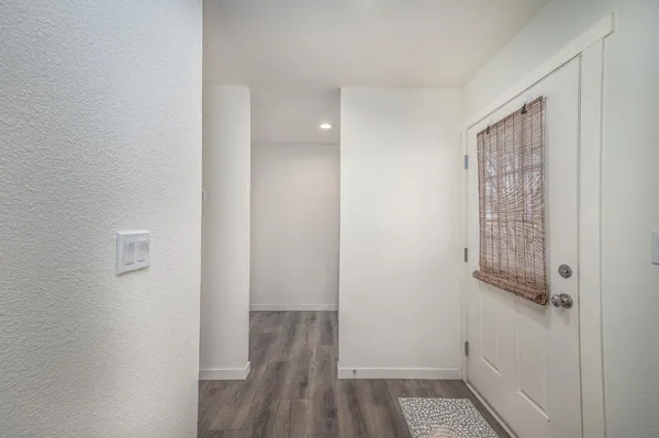 a view of hallway with wooden floor
