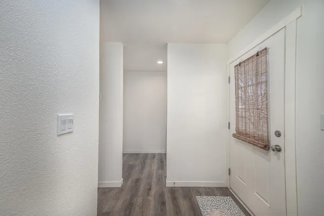 a view of hallway with wooden floor