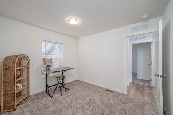 a view of a livingroom with furniture and staircase