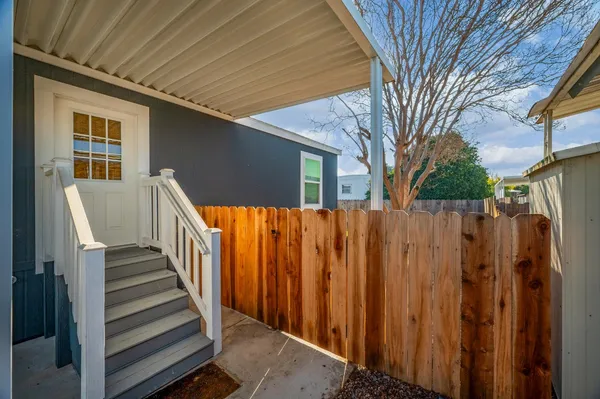 a view of a house with wooden fence