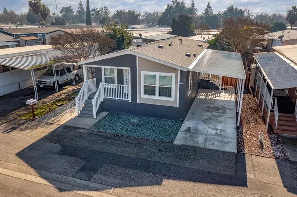 an aerial view of a house with a yard