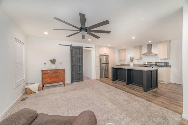 a large kitchen with stainless steel appliances kitchen island a refrigerator sink and cabinets