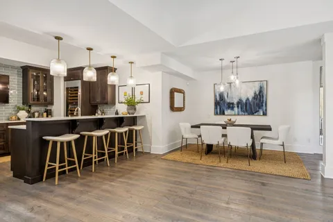 a view of a dining room with furniture and wooden floor
