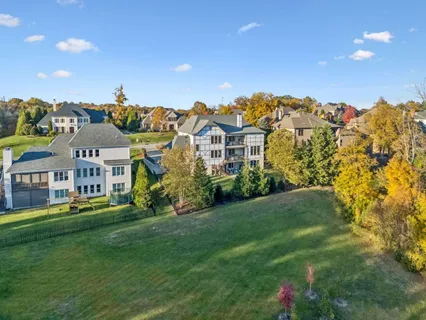 a view of a house with a yard and a fountain