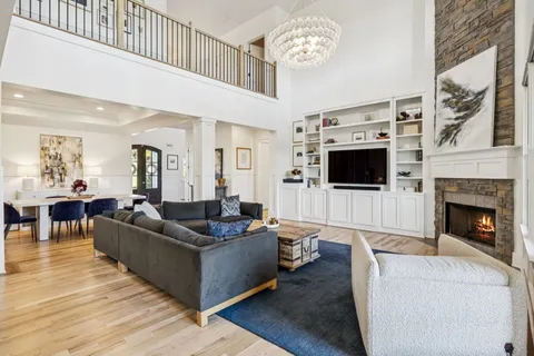 a living room with furniture a flat screen tv and a fireplace